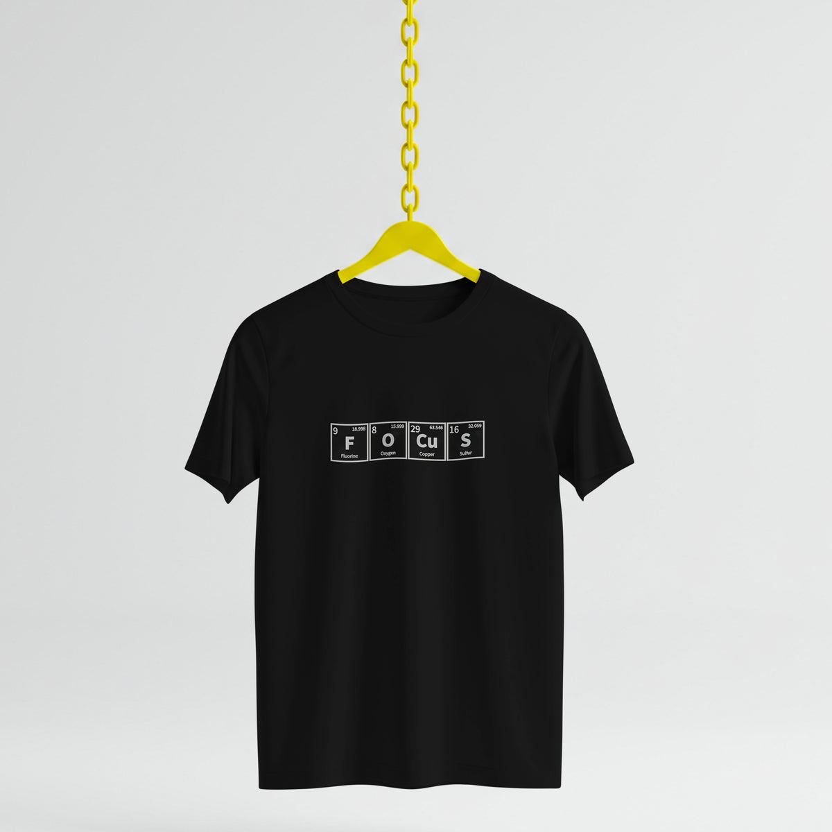 Black t-shirt with 'FOCUS' text on a yellow hanger against a light gray background