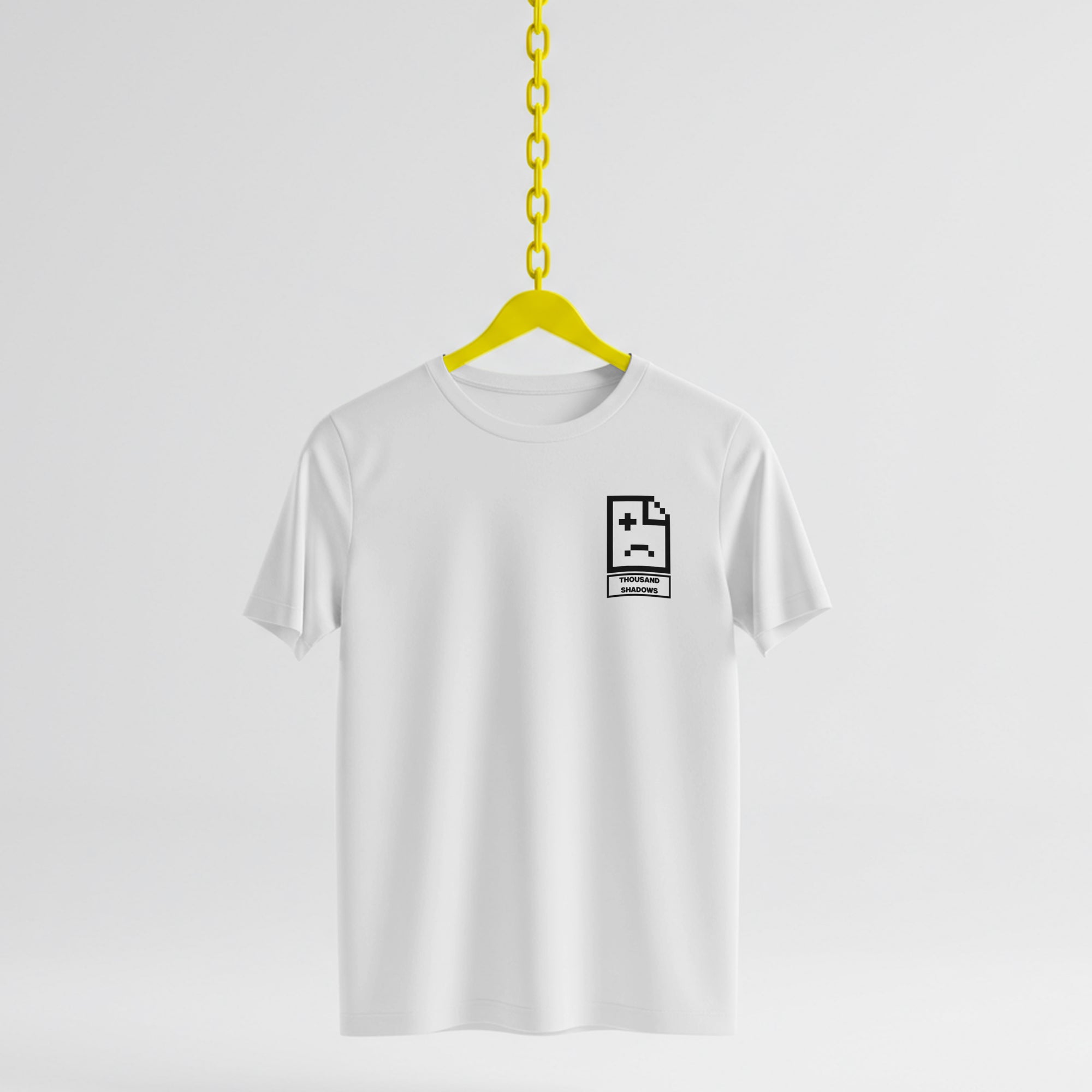 White t-shirt with a black graphic on a yellow hanger against a white background