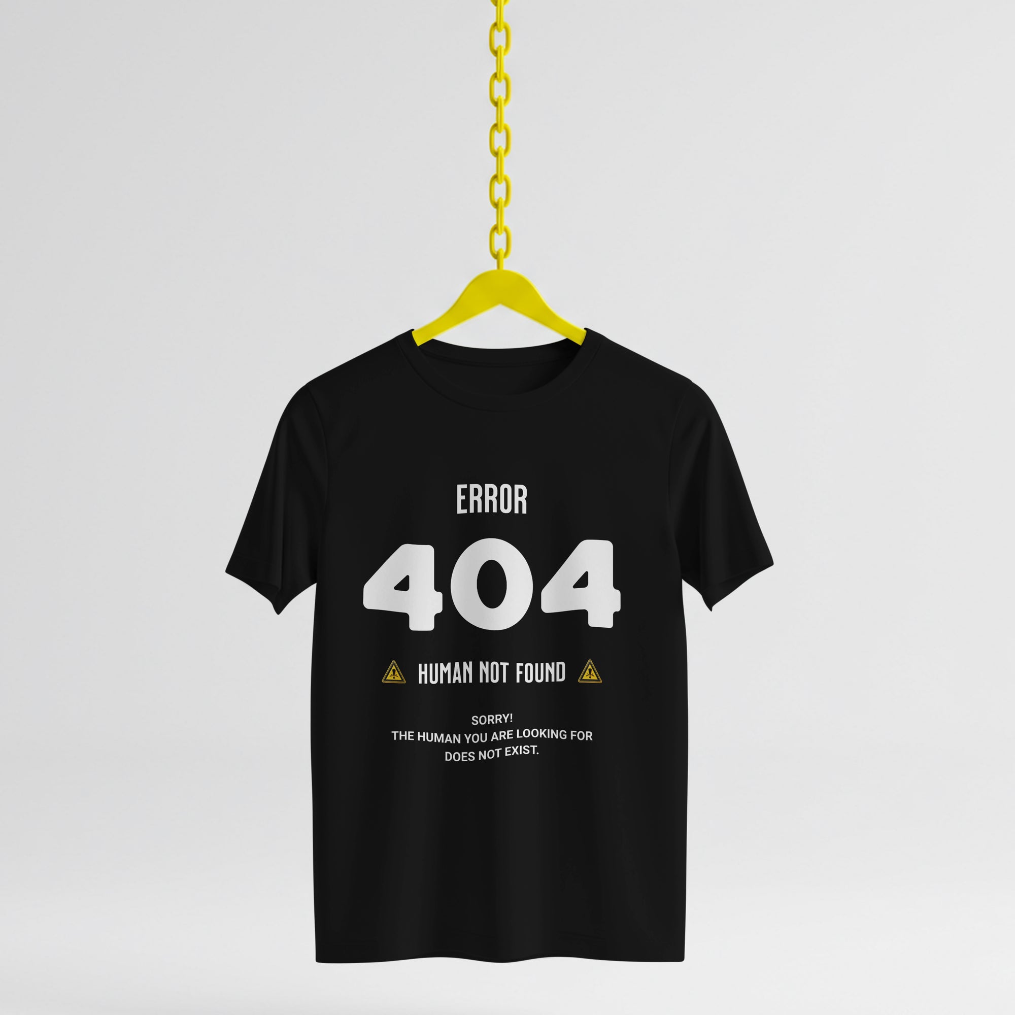 Black t-shirt with 'ERROR 404 HUMAN NOT FOUND' text on a yellow hanger against a white background